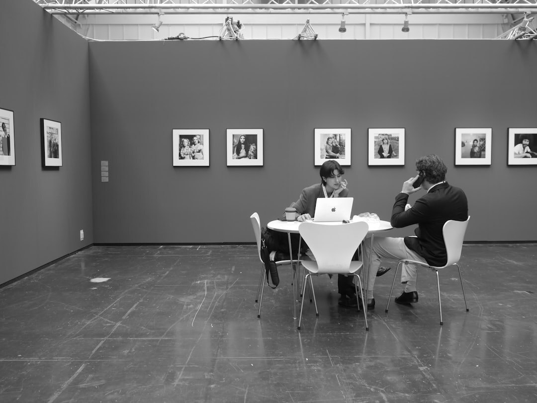 Visitors viewing black and white photography exhibition in a gallery